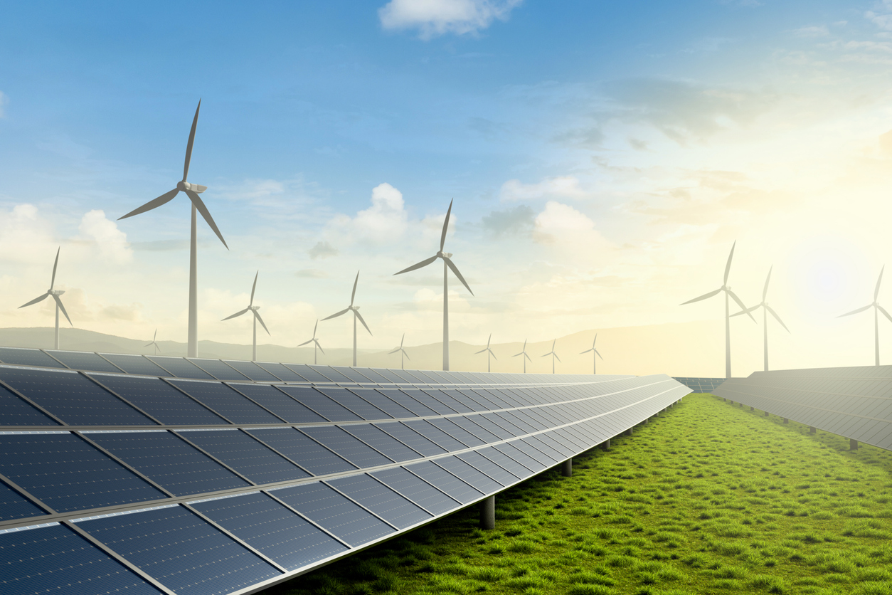 Solar farm and wind turbine on green fields