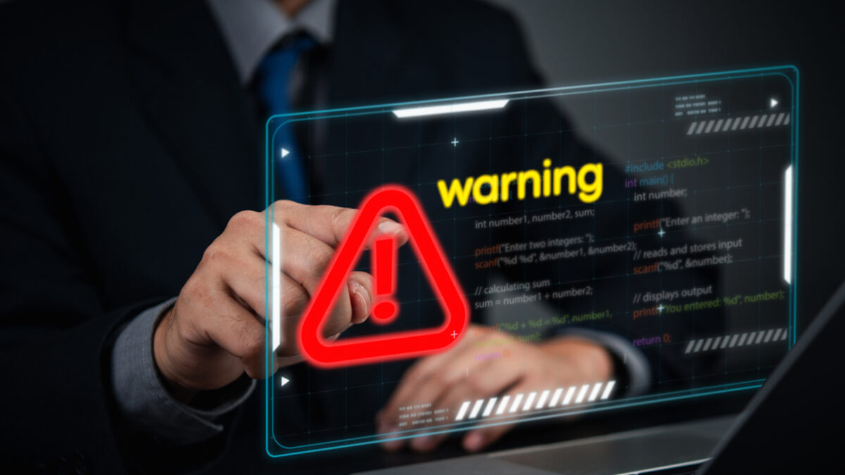 Cybersecurity coding warning concept. businessman pointing screen red alert sign, cyber threats, hacking risks, and system vulnerability. Digital security breach warning with a futuristic online threats.