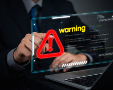 Cybersecurity coding warning concept. businessman pointing screen red alert sign, cyber threats, hacking risks, and system vulnerability. Digital security breach warning with a futuristic online threats.