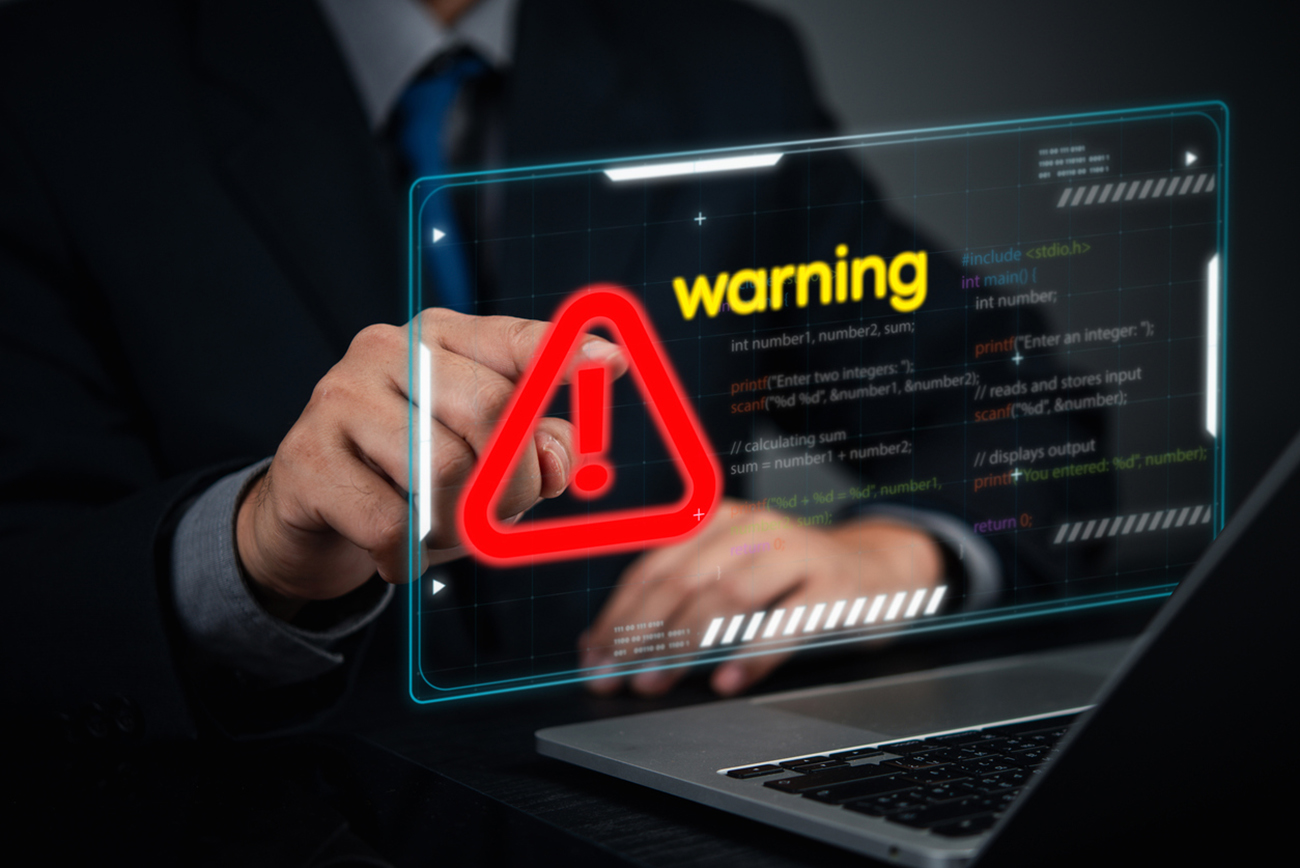 Cybersecurity coding warning concept. businessman pointing screen red alert sign, cyber threats, hacking risks, and system vulnerability. Digital security breach warning with a futuristic online threats.