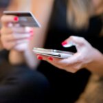 Mobile Payment, Close up hands holding credit card and using mobile smart phone