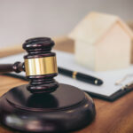 Gavel on sounding block at courtroom for decide home insurance, Law and justice concept, Settle a house dealing lawsuit.