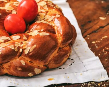 Easter traditional bread and red eggs on a table