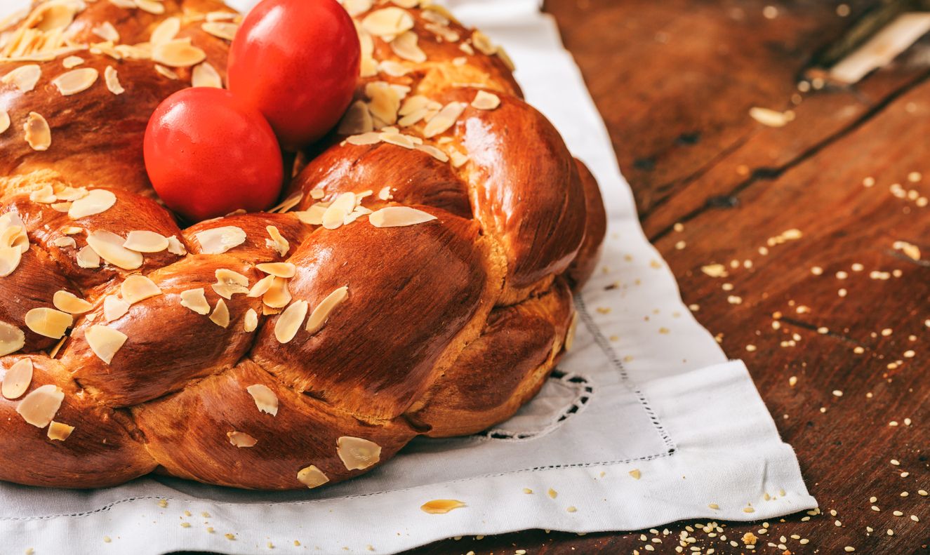 Easter traditional bread and red eggs on a table