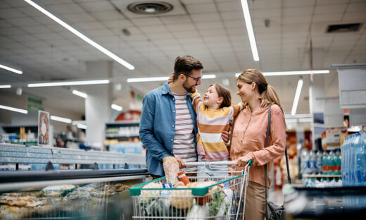 Happy embraced family enjoying in shopping at supermarket.