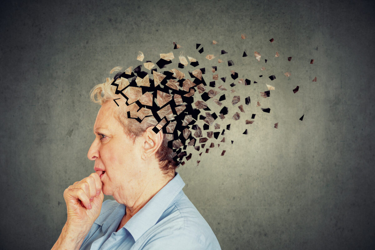 Memory loss due to dementia. Senior woman losing parts of head feeling confused as symbol of decreased mind function.
