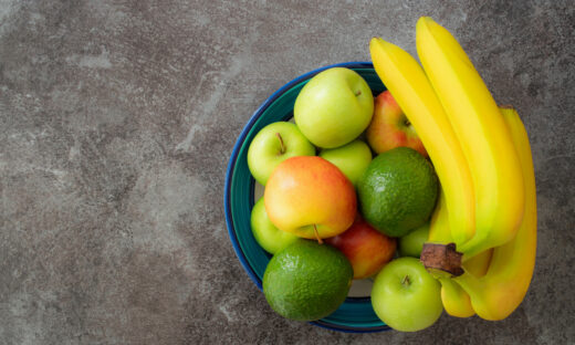 directly above shot of healthy fruits in pottery bowl on stone kitchen counter