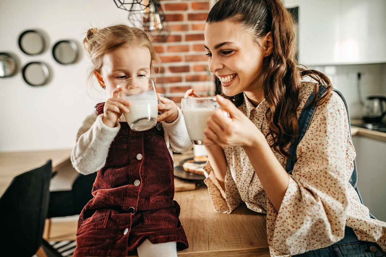 Mother and daughter having breakfast in kitchen