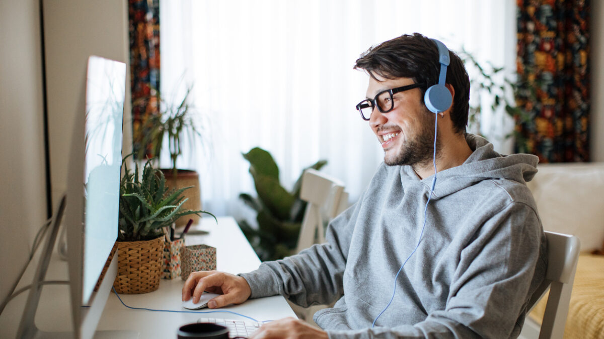 Young men playing video games with desktop
