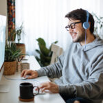 Young men playing video games with desktop