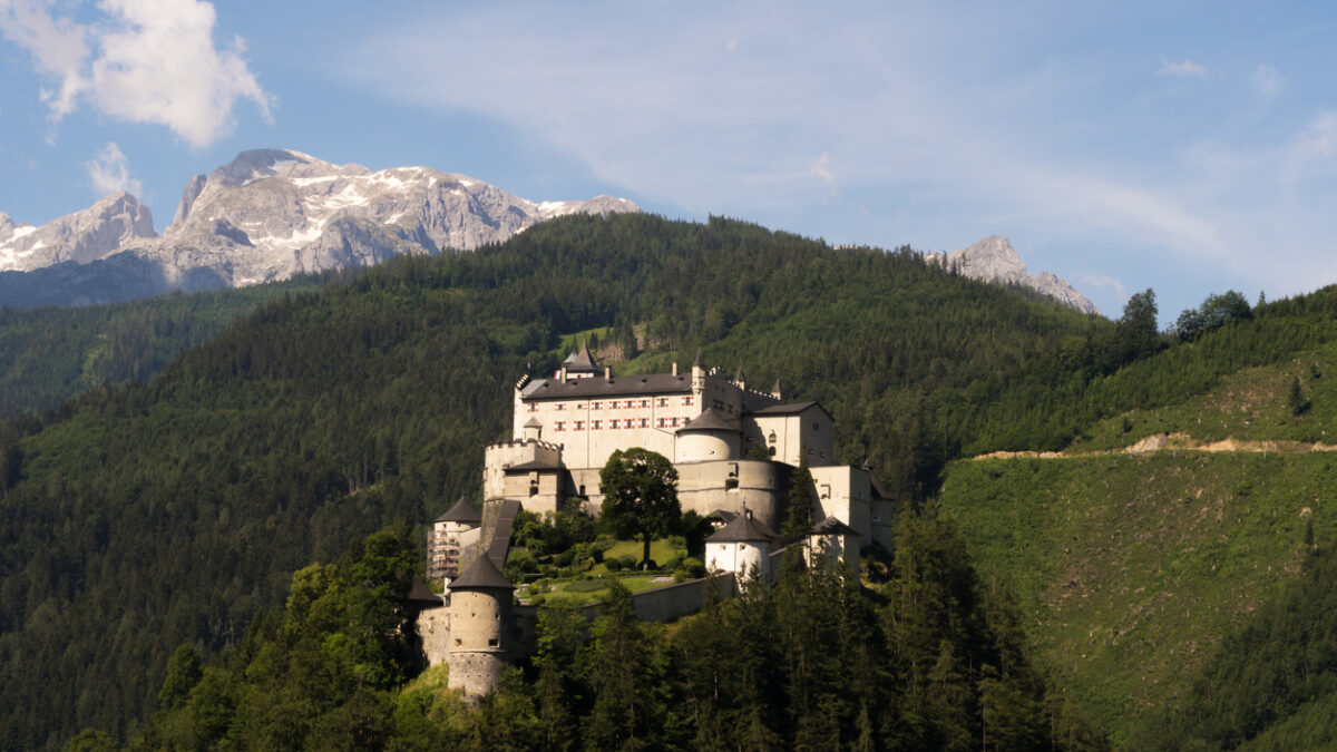 Werfen, Austria - June 27th, 2020: A view of the magnificent medieval Hohenwerfen Castle that is sitting on a rock and shines in the sunlight.