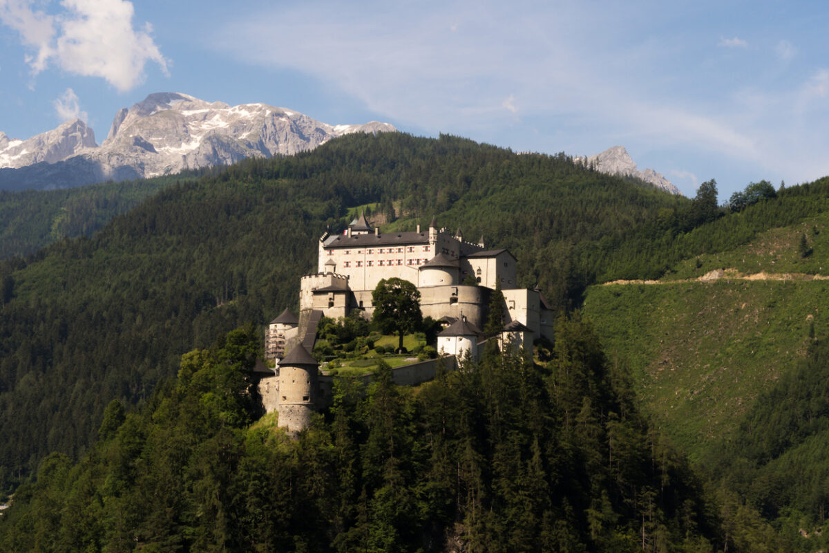 Werfen, Austria - June 27th, 2020: A view of the magnificent medieval Hohenwerfen Castle that is sitting on a rock and shines in the sunlight.