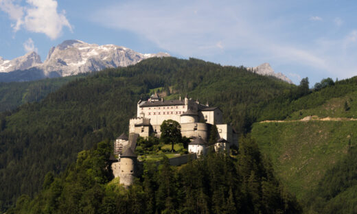 Werfen, Austria - June 27th, 2020: A view of the magnificent medieval Hohenwerfen Castle that is sitting on a rock and shines in the sunlight.
