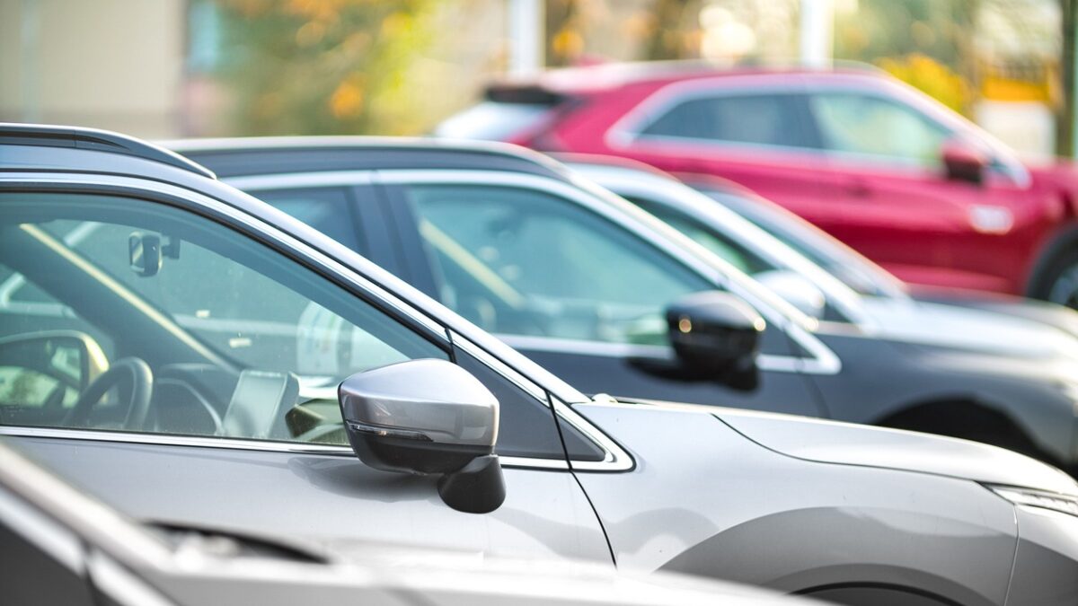 Side shot of a range of used modern vehicles, at a public car dealership