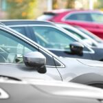 Side shot of a range of used modern vehicles, at a public car dealership