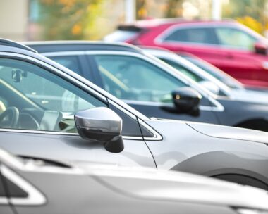 Side shot of a range of used modern vehicles, at a public car dealership