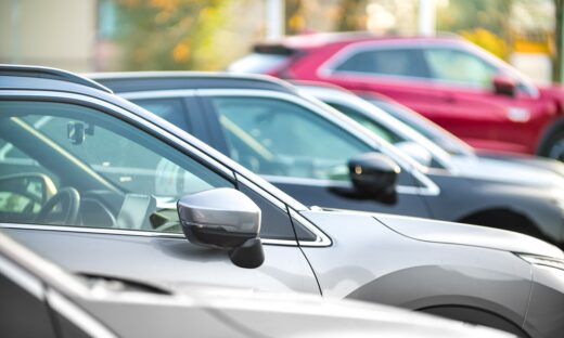 Side shot of a range of used modern vehicles, at a public car dealership