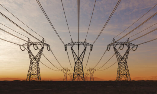 The silhouette of the high voltage power lines during sunset