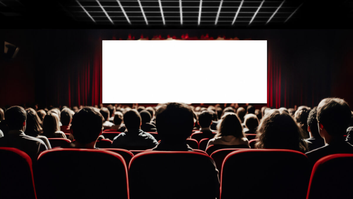 Cinema blank screen and people in red chairs in the cinema hall
