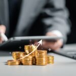Businessman collecting coins with profit chart analysis business growth, profit growth management and corporate financial statistics