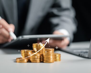 Businessman collecting coins with profit chart analysis business growth, profit growth management and corporate financial statistics