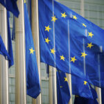 "EU flags fly in a row in front of the European Commission building in Brussels, Belgium"