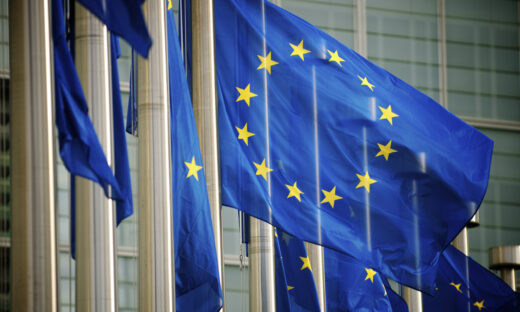 "EU flags fly in a row in front of the European Commission building in Brussels, Belgium"