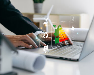 Hand of businessman using laptop with energy efficiency rating