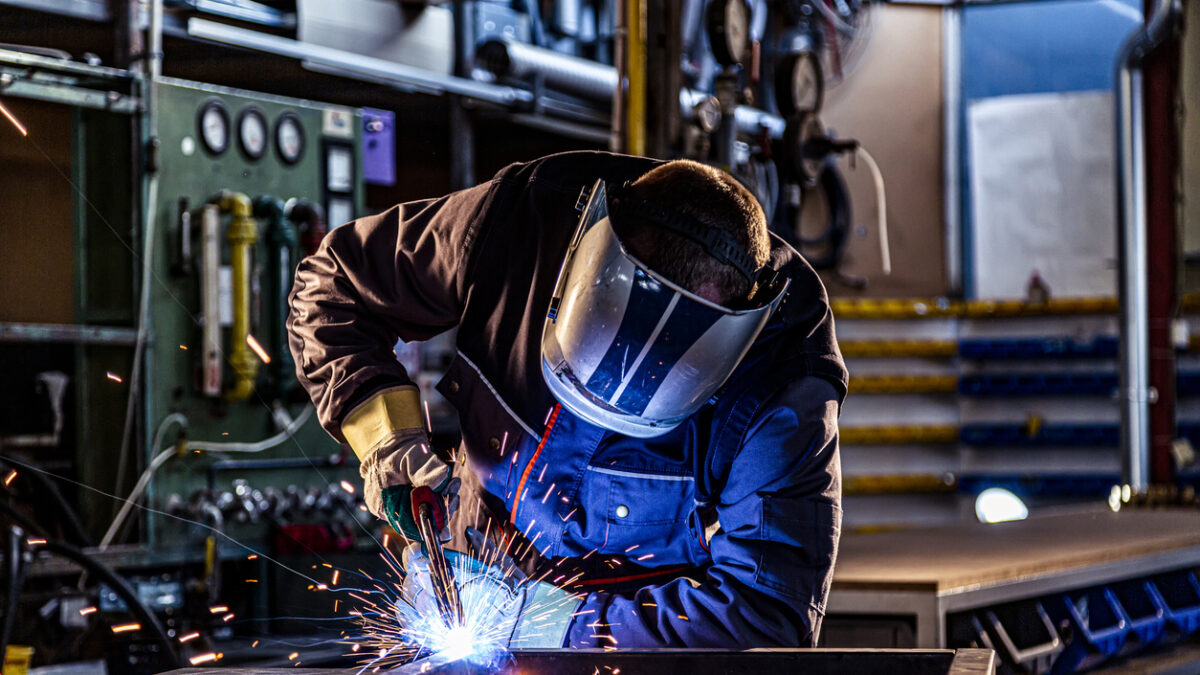 Industrial worker welding at the factory