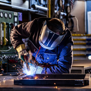 Industrial worker welding at the factory