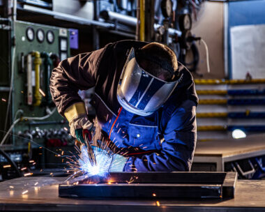 Industrial worker welding at the factory
