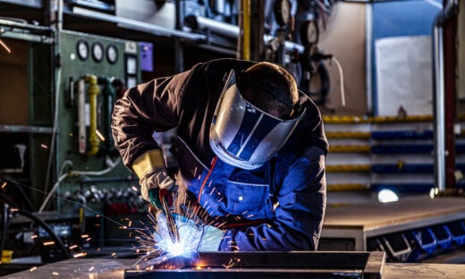 Industrial worker welding at the factory