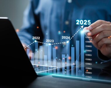 Businessman analyzes the graph of trend market growth in 2025 and plans business growth and profit increase in the year 2025. plan finances of the business