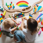 Children drawing and making crafts in kindergarten or daycare