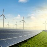 Solar farm and wind turbine on green fields