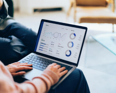 Focused on a laptop, showcasing detailed analytics and reports