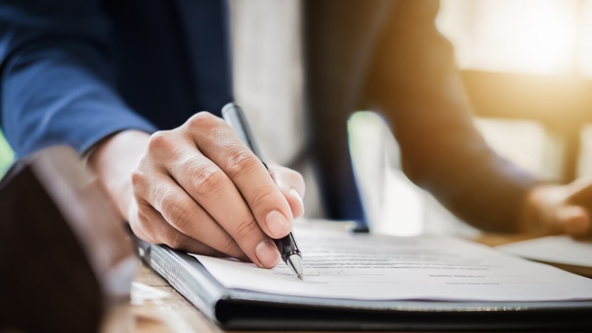 estate agent gives pen and documents agreement with customer to sign contract. Concept agreement