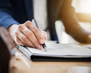 estate agent gives pen and documents agreement with customer to sign contract. Concept agreement