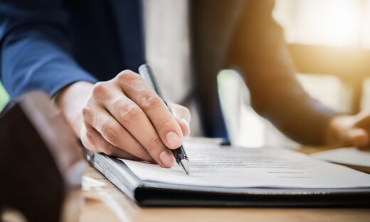estate agent gives pen and documents agreement with customer to sign contract. Concept agreement