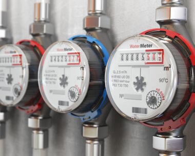 Row of water meters of cold and hot water on the wall
