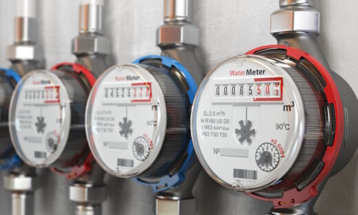 Row of water meters of cold and hot water on the wall