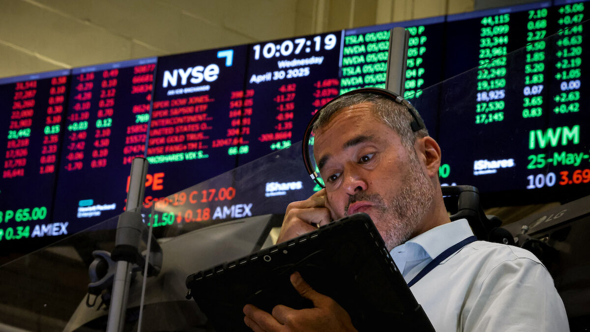Traders work on the floor of the NYSE in New York