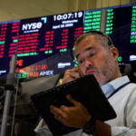 Traders work on the floor of the NYSE in New York