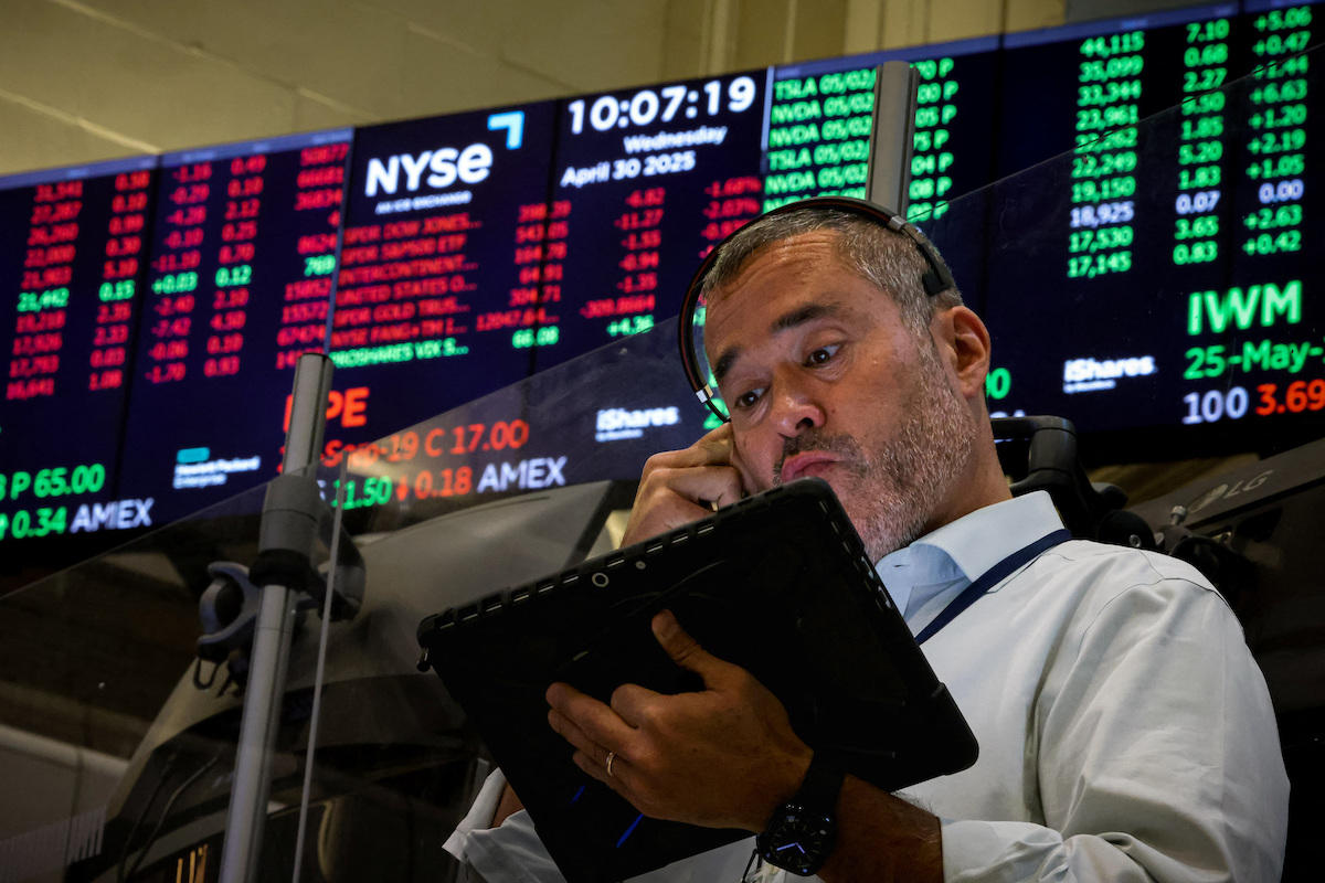 Traders work on the floor of the NYSE in New York