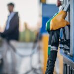 One man, pouring gasoline in his car at the gas station