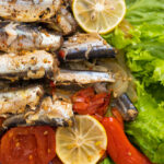 Fish stewed in vegetables with lemon. Culinary background with selective focus and blurred background.