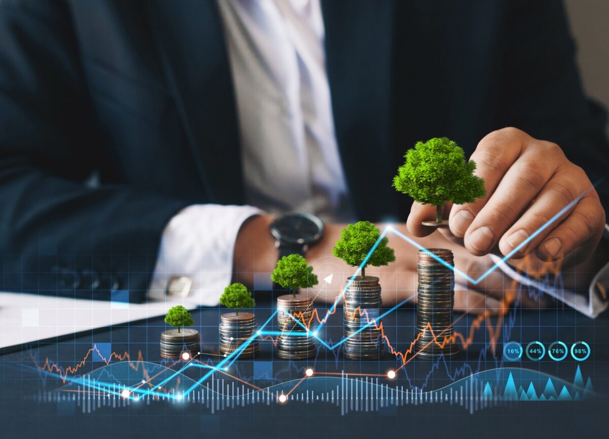 Eco business investment. Green business growth. Businessman holding coin with tree growing on money coin stack. Finance sustainable development. Concept of pass and increase of renewable energy