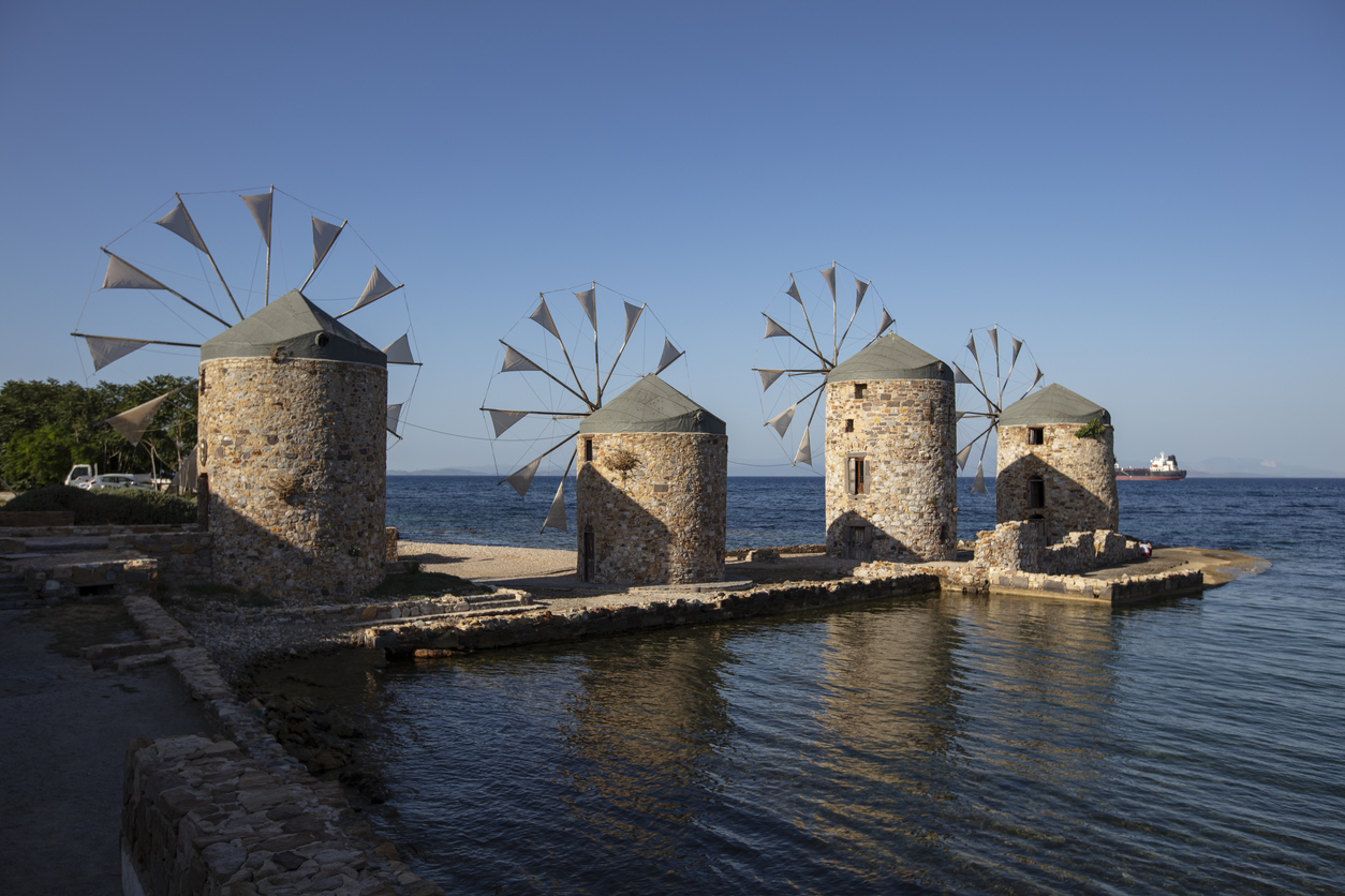 Old windmills by the beach, Chios island, Greece.