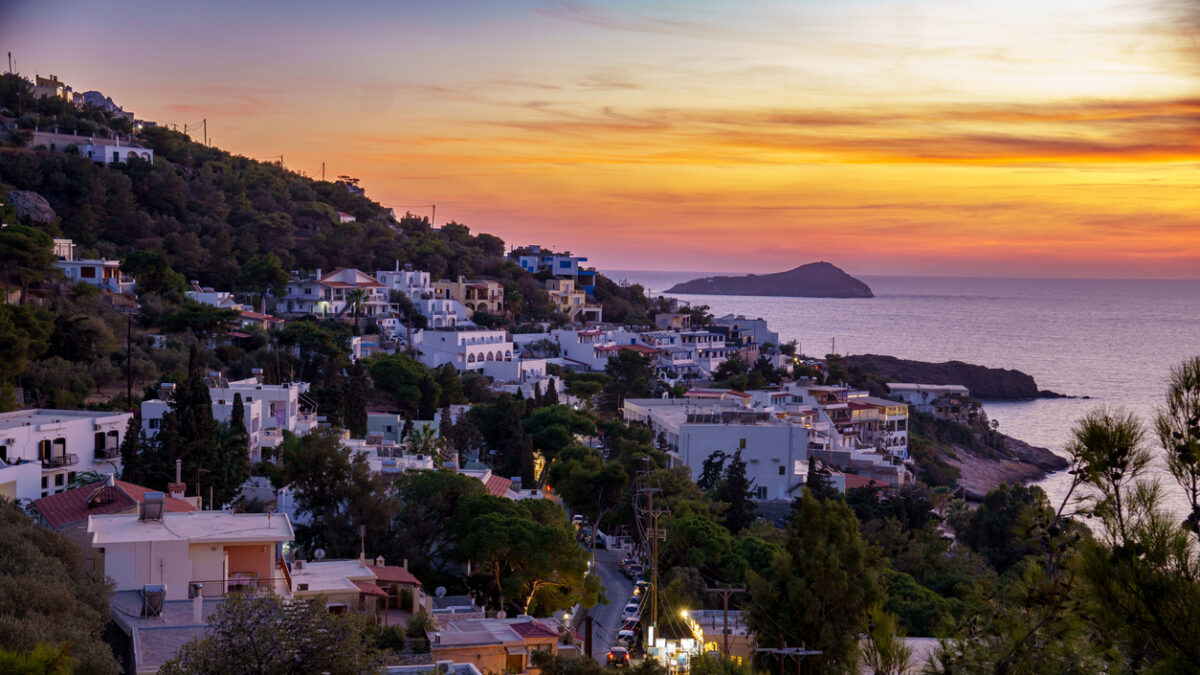 Sunset on Kalymnos, Greece. View over the village of Massouri to the sea with orange colored sky of the setting sun