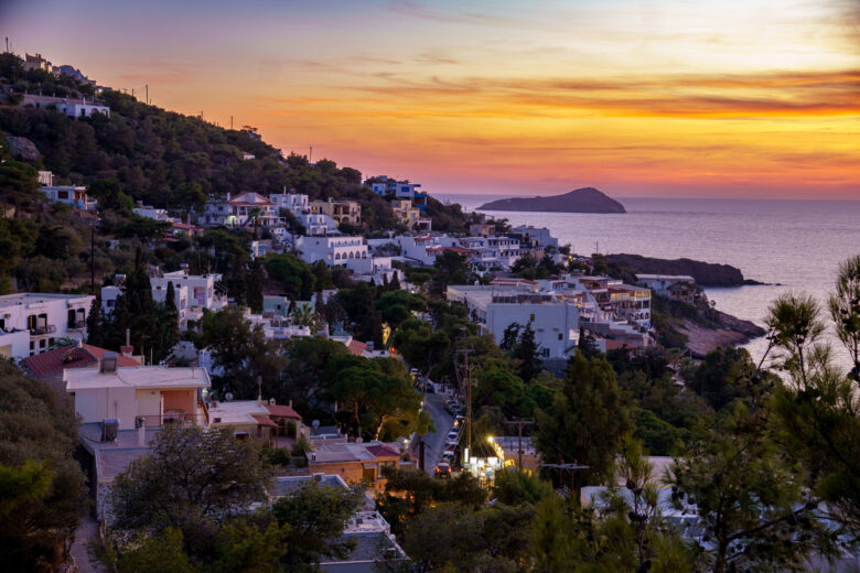 Sunset on Kalymnos, Greece. View over the village of Massouri to the sea with orange colored sky of the setting sun